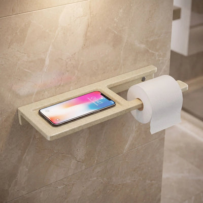 Bathroom shelf with phone holder and toilet paper roll on tiled wall