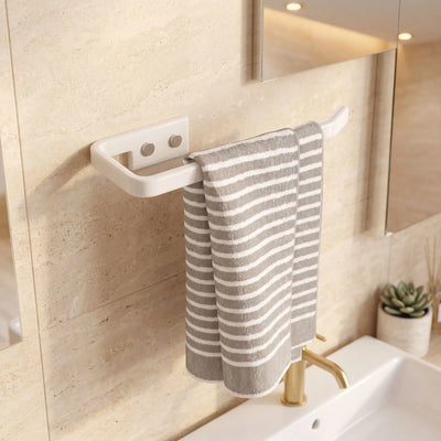 Towel hanging on a white towel rack in a bathroom with a sink and mirror.