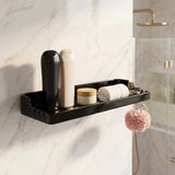 Black wall-mounted shower caddy with toiletries on a marble wall