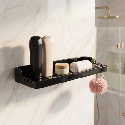 Black wall-mounted shower caddy with toiletries on a marble wall