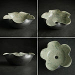 Floral-shaped ceramic bowl on a dark background