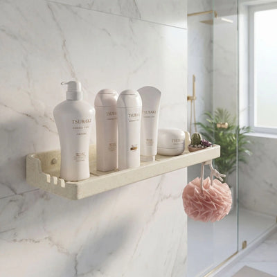 Bathroom shelf with Tsukaido skincare products against a marble wall.