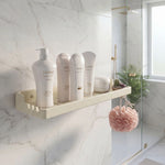Bathroom shelf with Tsukaido skincare products against a marble wall.