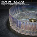 Glass table with ribbed design and gold base on a dark surface, highlighting premium thick glass quality.
