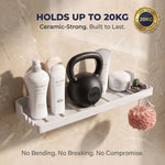 White wall shelf holding bottles, a kettlebell, and other items against a beige marble background.