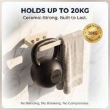 Kettlebell holder with a 20kg kettlebell on a marble surface, featuring text about its strength and durability.