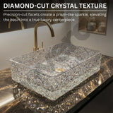 Crystal glass basin with diamond-cut texture on a marble countertop