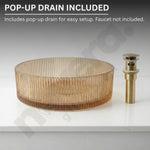 Glass sink basin with gold pop-up drain on a white background