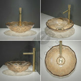 Glass sink with gold faucet on a gray background