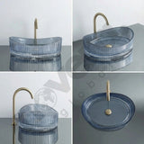 Blue glass sink with gold faucet on a gray surface