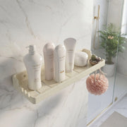 Bathroom shelf with skincare products and a plant in a modern bathroom setting