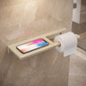 Bathroom shelf with phone holder and toilet paper roll on tiled wall