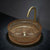 Round glass sink with gold faucet on a dark surface
