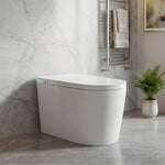 Modern freestanding bathtub in a bathroom with marble walls and a plant.