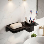 Bathroom shelf with soap, toothbrushes, and a plant on a marble wall.