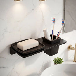 Bathroom shelf with soap, toothbrushes, and a plant on a marble wall.
