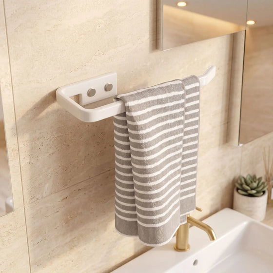 Towel hanging on a white towel rack in a bathroom with a sink and mirror.