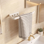 Towel hanging on a white towel rack in a bathroom with a sink and mirror.