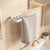 Towel hanging on a white towel rack in a bathroom with a sink and mirror.