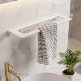Towel rack with striped towels on a marble wall in a bathroom setting