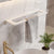 Towel rack with striped towels on a marble wall in a bathroom setting