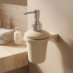 Beige soap dispenser mounted on a bathroom wall with a neutral color scheme.