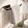 Striped towel hanging on a black towel rack in a bathroom.