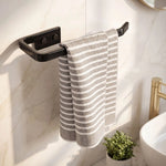 Striped towel hanging on a black towel rack in a bathroom.