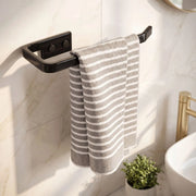 Striped towel hanging on a black towel rack in a bathroom.