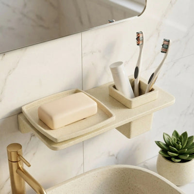 Bathroom shelf with soap, toothbrushes, and a plant on a marble wall background