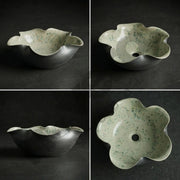 Floral-shaped ceramic bowl on a dark background