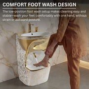 Person washing feet in a unique foot wash design with gold fixtures.