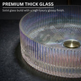 Glass table with ribbed design and gold base on a dark surface, highlighting premium thick glass quality.