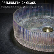 Glass table with ribbed design and gold base on a dark surface, highlighting premium thick glass quality.