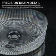 Clear precision drain with detailed design on a black background
