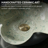 Handcrafted ceramic art piece with a rich glazed surface and gold accent.