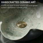 Handcrafted ceramic art piece with a rich glazed surface and gold accent.