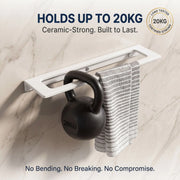 Kettlebell hanging on a white rack with text about weight capacity and durability.