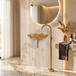 Luxurious bathroom with gold sink and faucet, marble tiles, and decorative elements.