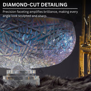 Close-up of a crystal object with diamond-cut detailing on a dark background