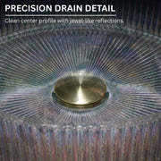 Close-up of a glass object with a gold center and text about precision drain detail.