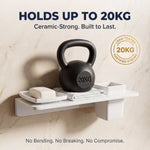 White shelf with a black kettlebell labeled '20KG' on a beige marble background, emphasizing durability.
