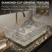 Crystal glass basin with diamond-cut texture on a marble countertop