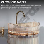 Glass sink with bronze faucet on a gray background, featuring 'Edera' branding.