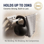 Wall-mounted hook holding a kettlebell with text about its capacity and features.