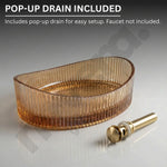 Brown glass sink basin with gold pop-up drain on a gray background