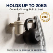 Black kettlebell with '20KG' marking on a white wall with text about weight capacity and durability.