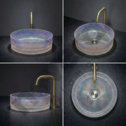 Glass sink with gold faucet on a dark background