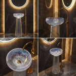 Bathroom sink with gold faucet and illuminated mirror in a dark room.
