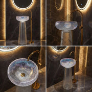 Bathroom sink with gold faucet and illuminated mirror in a dark room.